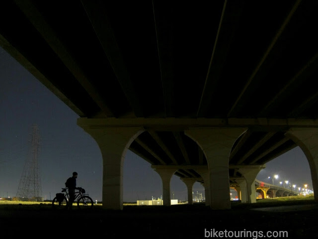 Picture of bike commuter and bridge at night