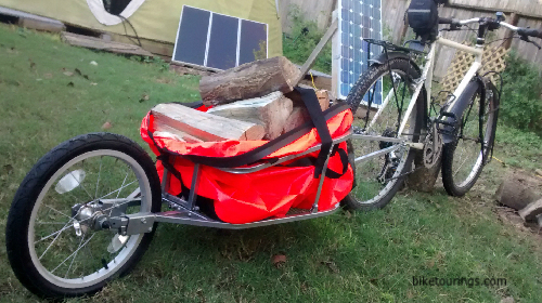 Picture of bike trailer filled with fire wood.