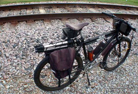 Picture of touring bike on gravel road with panniers