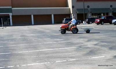 Picture of old man commuting on a lawn mower