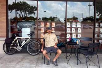 Picture of bike commuter sitting outside coffee shop