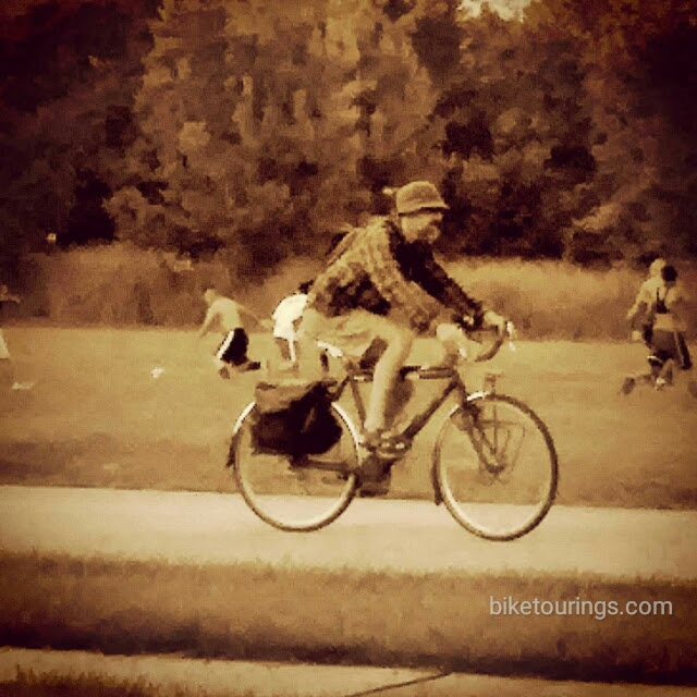 Picture of bike commuter riding touring bike