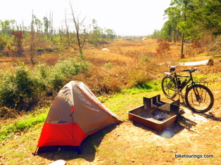 Picture of mountain bike for touring and tent for bike camping.