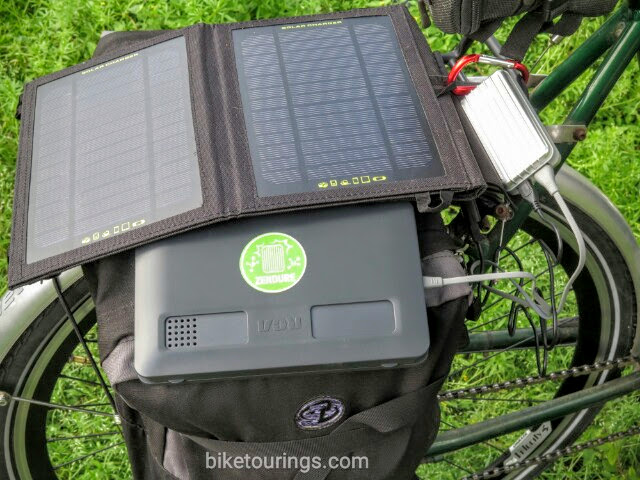 Picture of solar panel with power bank on touring bike while charging tablet