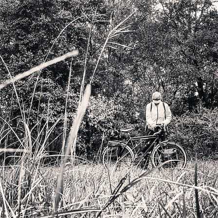 Picture of touring bike and rider in meadow while bicycle touring and camping
