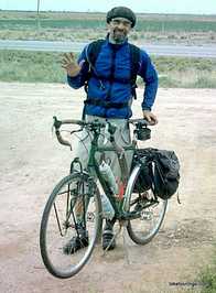 Picture of man with his bike while bicycle touring for bike touring interviews